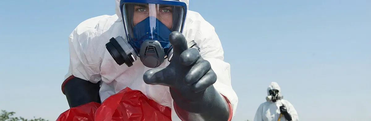 sewage clean up technician wearing protective gear handling biohazard materials in Tampa, FL