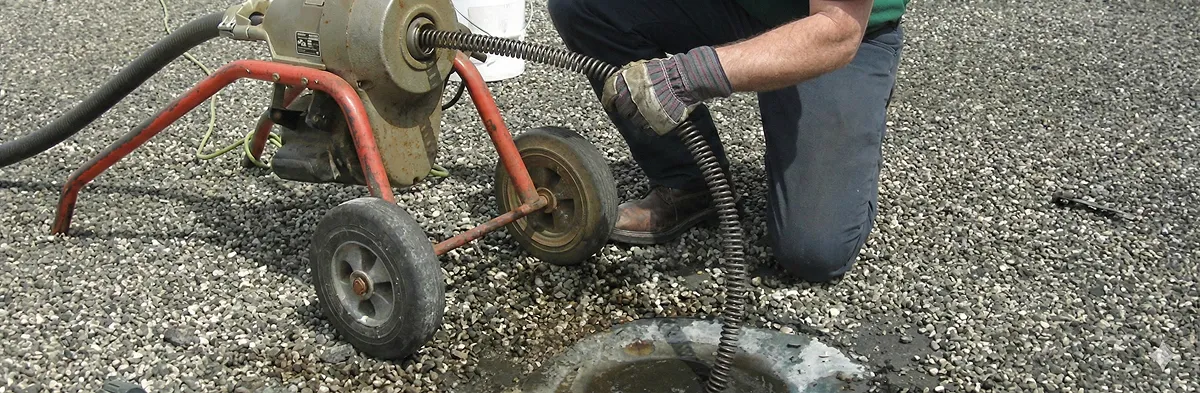sewer rodding technician actively removing blockages from a sewer line in Tampa, FL